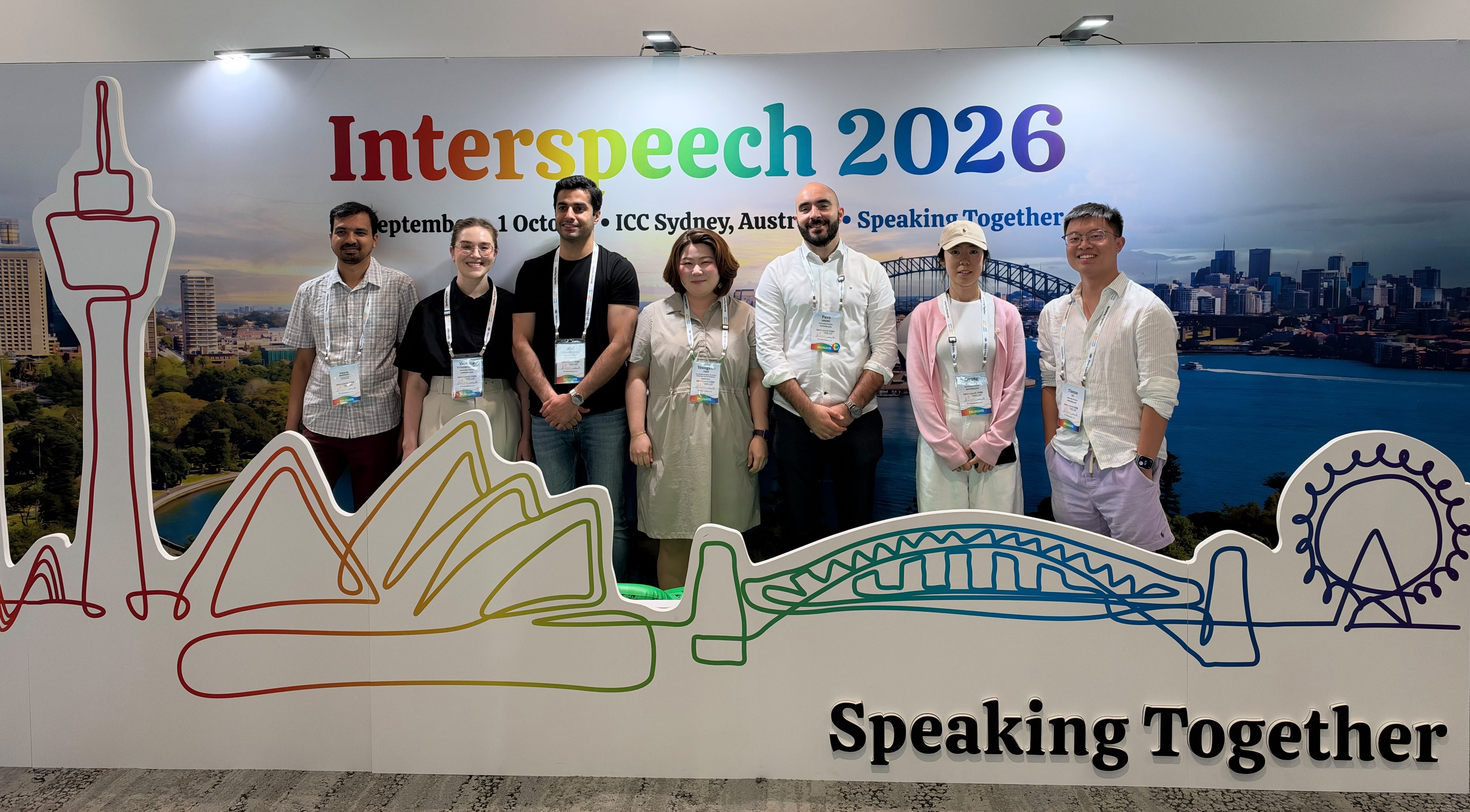 Members of CL and LiRI gathered in front of the Interspeech 2026 backdrop