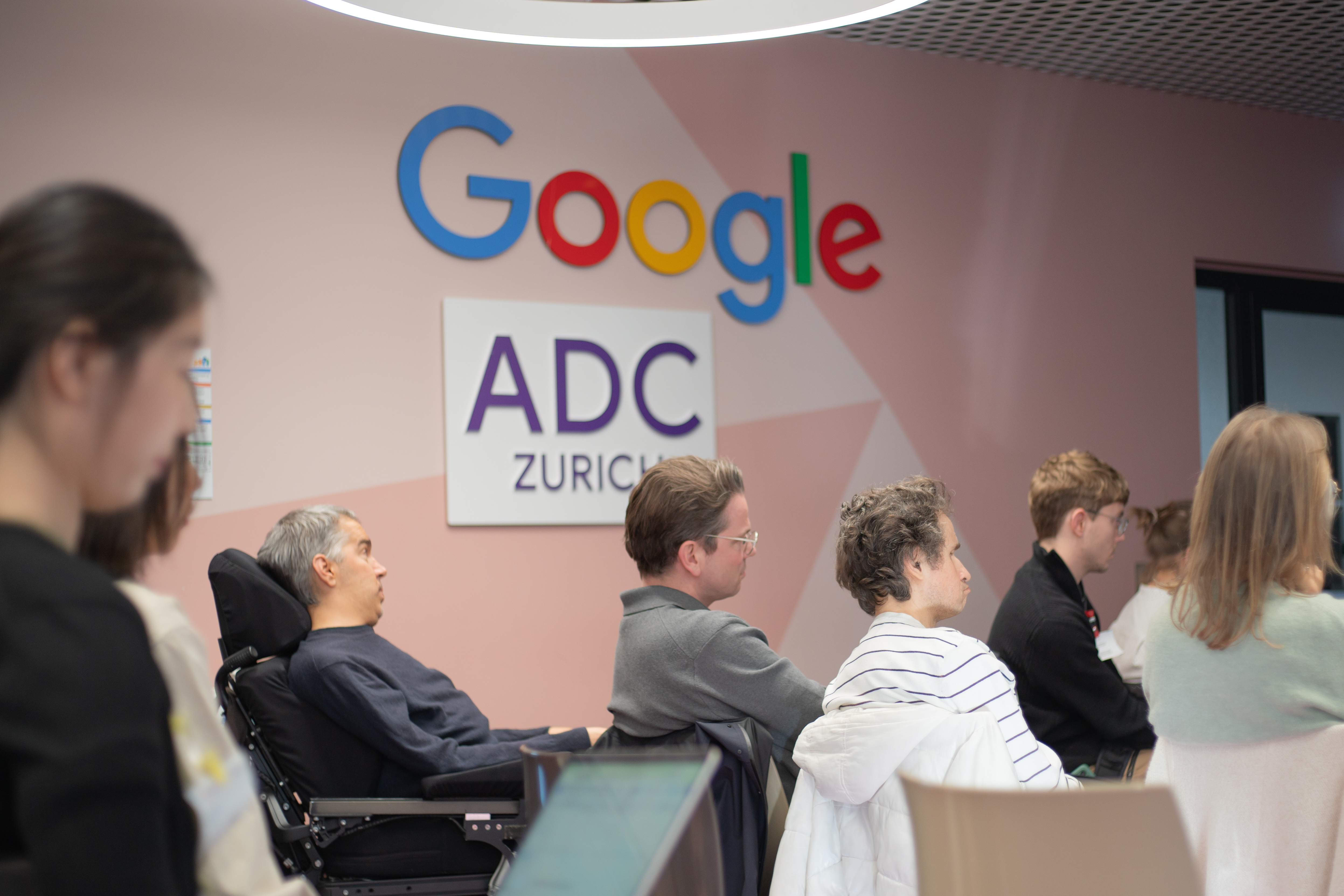 Group of workshop participants sitting in front of the Google ADC logo